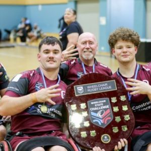 Queensland Wheelchair Maroons Team Members Holding Up State Challenge Shield